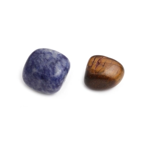 Detailed view of natural blue marble and brown tiger eye stones on white background
