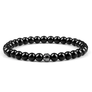 Polished black gemstone beads bracelet with a gray hexagonal metallic spacer bead detail