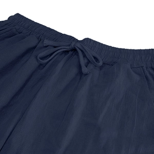 Detail of navy blue linen trousers showing elastic waistband with matching drawstring