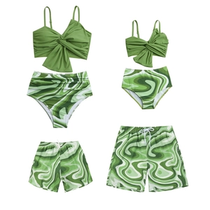 Family matching swimwear set in green and marble print with bikini and swim trunks