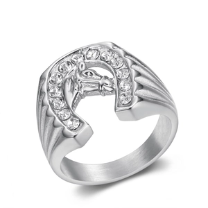 Silver horseshoe ring with horse head motif and sparkling rhinestones on white background
