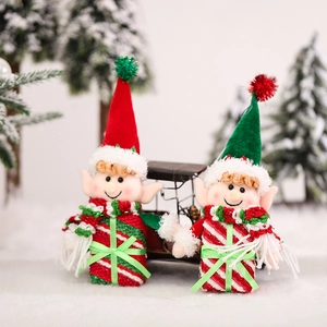 Christmas elf plush gnome ornaments with red and green hats in a festive snow scene
