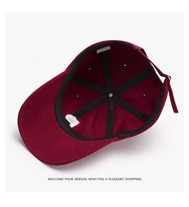 Detailed interior of the burgundy cotton baseball cap showing stitching and inner label