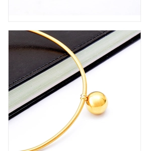 Close-up of minimalist gold snake chain necklace featuring a polished spherical bead pendant