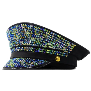 Detail of black captain hat with iridescent rhinestones and gold star button accent