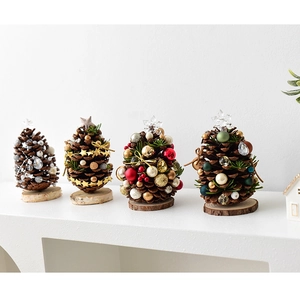 Set of four mini pine cone Christmas trees with wooden bases and festive decorations