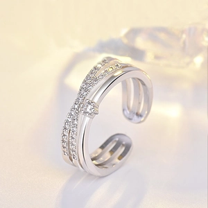 Crisscross layered open ring with sparkling white cubic zirconia in silver-plated metal