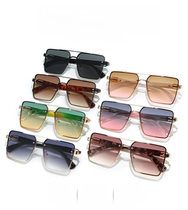 Detail showing seven pairs of oversized square sunglasses in multiple gradient lens colors