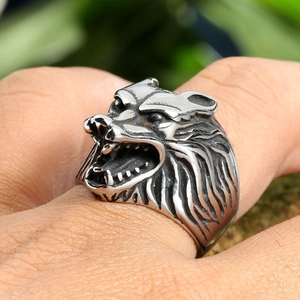 Detailed close-up of a vintage wolf head steel ring with aged silver finish on hand