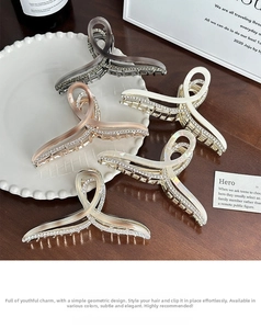 Close-up of assorted rhinestone hair claws in various colors on a ceramic plate
