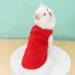 Detail of red fleece pet vest with leash D-ring on a cat, soft warm fabric texture