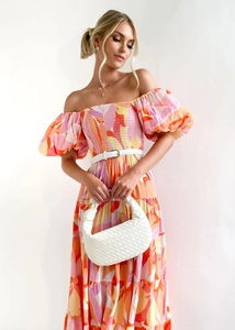 Detail of off-shoulder floral maxi dress with puff sleeves and white woven belt accessory
