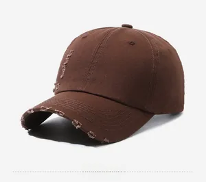 Detailed side view of washed brown vintage baseball cap featuring distressed torn details