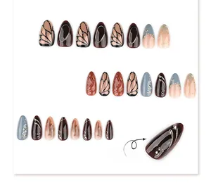 Macro detail of 3D stiletto nails with marble art and golden embossed lines
