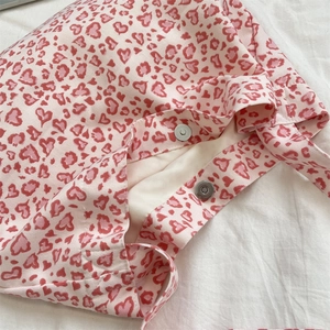 Close-up of heart leopard print canvas tote with secure magnetic metal clasp detail