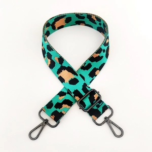 Detail of adjustable leopard print wide strap with dark grey metallic lobster hooks