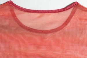 Detail of the crew neck collar featuring fine orange mesh fabric and reinforced stitching