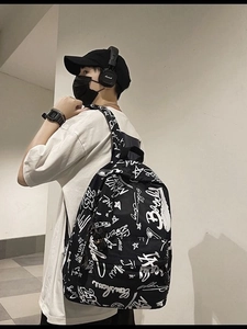 Street style black canvas backpack with white graffiti prints and large main compartment