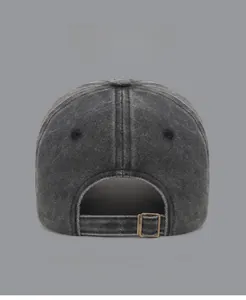 Close-up of washed gray cotton baseball cap featuring an adjustable bronze metal buckle