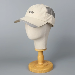 Quick-dry mesh baseball cap with Mod embroidery and grey trim on a beige visor