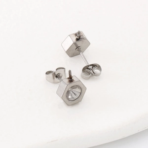Macro shot of silver hexagonal stainless steel stud earring settings with butterfly backs