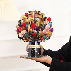 Detailed close-up of a 3D pop-up birthday card with colorful balloons and gold accents