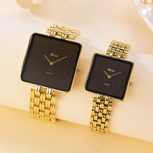 Detailed view of gold square quartz watches with black dials for couples on beige stand