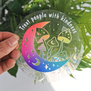 Prism suncatcher window sticker featuring a moon and mushroom design with kindness quote