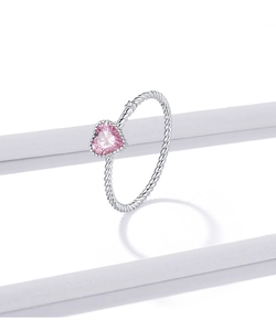 Macro detail of a s925 silver ring featuring pink heart gemstone and twisted band