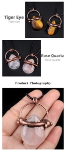 Detail of tear-drop tiger eye and rose quartz pendants with vintage bronze wire wrap