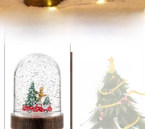 Detail of Christmas lantern featuring a red vintage truck and snow-covered trees inside