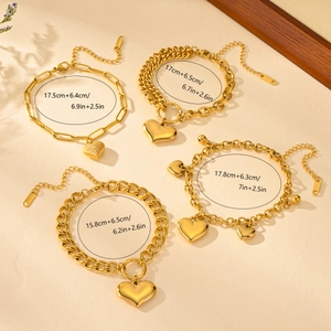 Detail of four gold heart pendant bracelets with size labels and various chain links