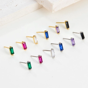 Macro shot of rectangular zircon earrings in gold and silver plating with multiple colors