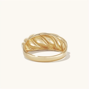 Detailed view of a gold croissant ring featuring bold ribbed texture and polished finish