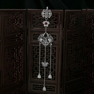 Detailed view of silver plum blossom fan brooch with tassels and good fortune lock charm