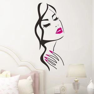 Minimalist wall decal of female face with bright pink lips in a modern bedroom setting