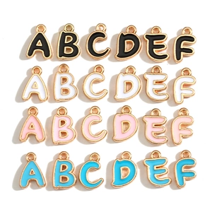Detailed view of colorful enamel letter pendants A to F in four vibrant colors