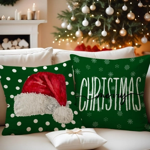 Detailed view of green Christmas pillow covers with red hat and merry artistic typography