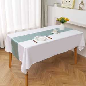 Teal satin table runner on white tablecloth with elegant drape for wedding decor