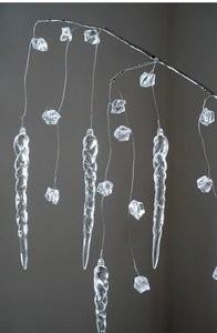 Macro detail of clear acrylic icicles and crystal bead droplets on a silver branch