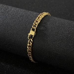Polished gold curb chain bracelet with secure lobster clasp on black display