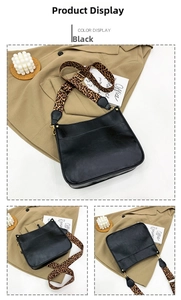 Detail of black tote bag with leopard print shoulder strap and gold hardware