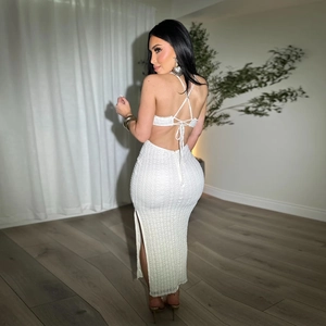 Detail view of white halter neck maxi dress with backless design and side slit feature