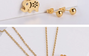 Detailed macro view of gold elephant necklace pendant and round stud earrings set
