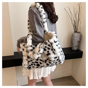 Detail of plush cow print tote bag showing soft faux fur texture on shoulder