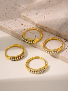 Detailed set of four gold stainless steel rings with colorful zircon and shell pearls