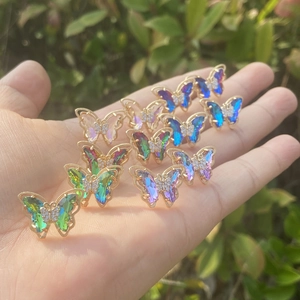 Gradient butterfly stud earrings with 925 silver needles and gold-plated frames on hand