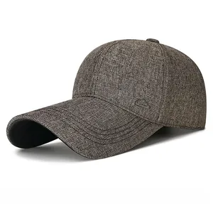 Detailed macro view of the metal mountain logo on the textured dark brown baseball cap