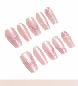 Detail of pink cat-eye press-on nails with 3D embossed mermaid tail and petal textures