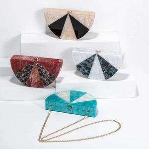 Detail of assorted marble pattern acrylic clutch bags with gold chain shoulder straps
